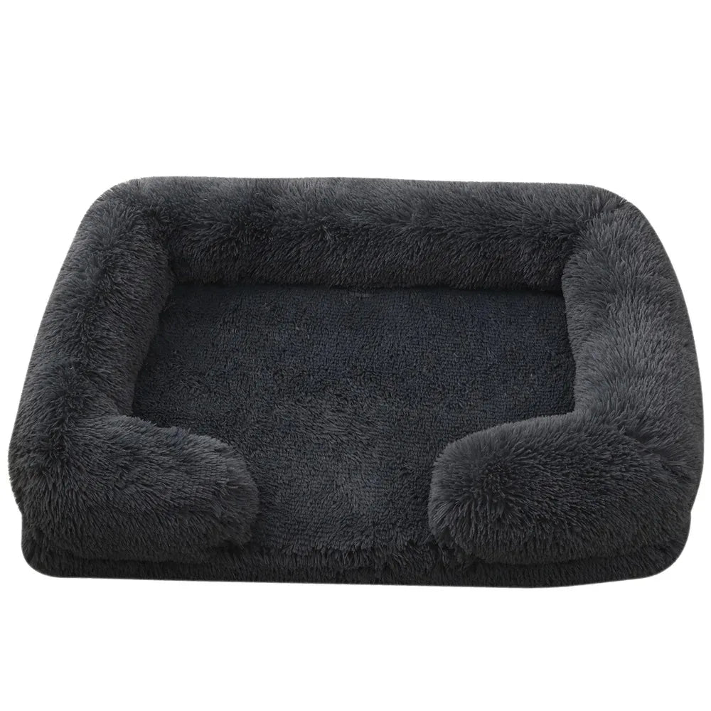 Fluffy dog bed in charcoal shaggy plush with bolsters round the back and sides and a flat padded base