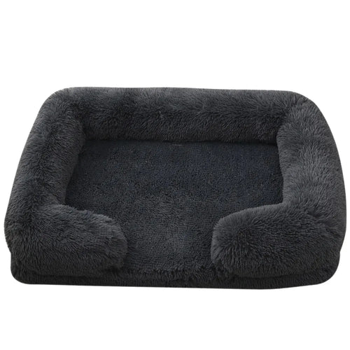 Fluffy dog bed in charcoal shaggy plush with bolsters round the back and sides and a flat padded base