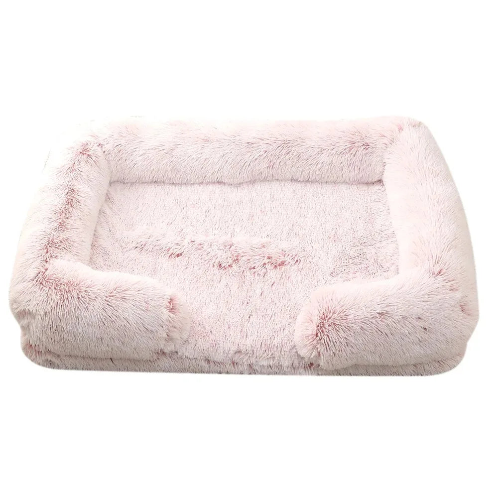 Fluffy dog bed in frosted pink, pale pink shaggy plush with darker roots, bolsters on three sides
