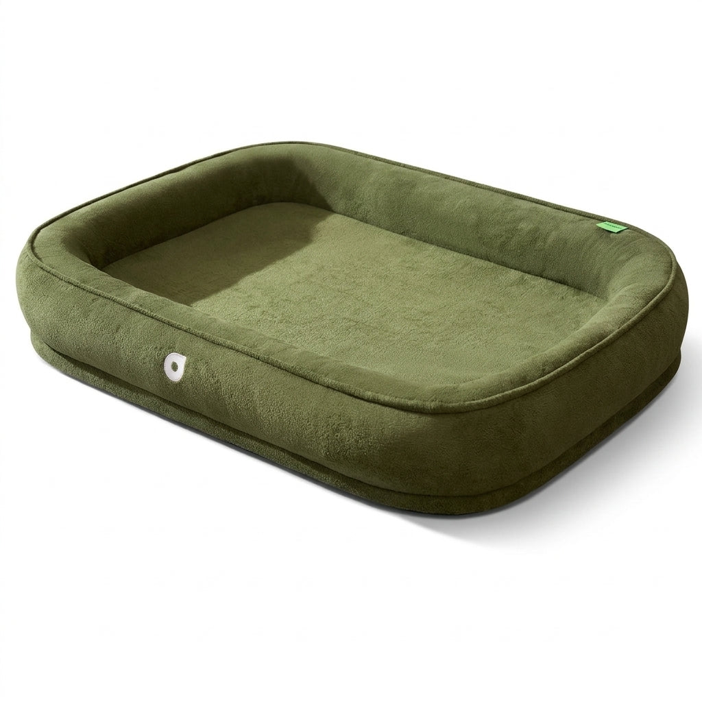High sided dog bed in olive green plush with a thick rounded bolster on all four sides