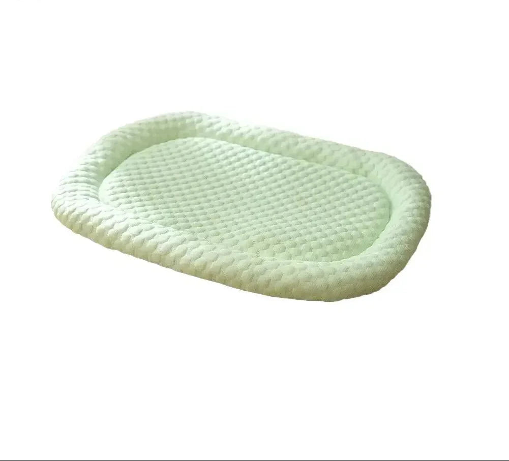 Ice silk cool bed for dogs in pale green, oval with a raised bolster and a quilted textured surface