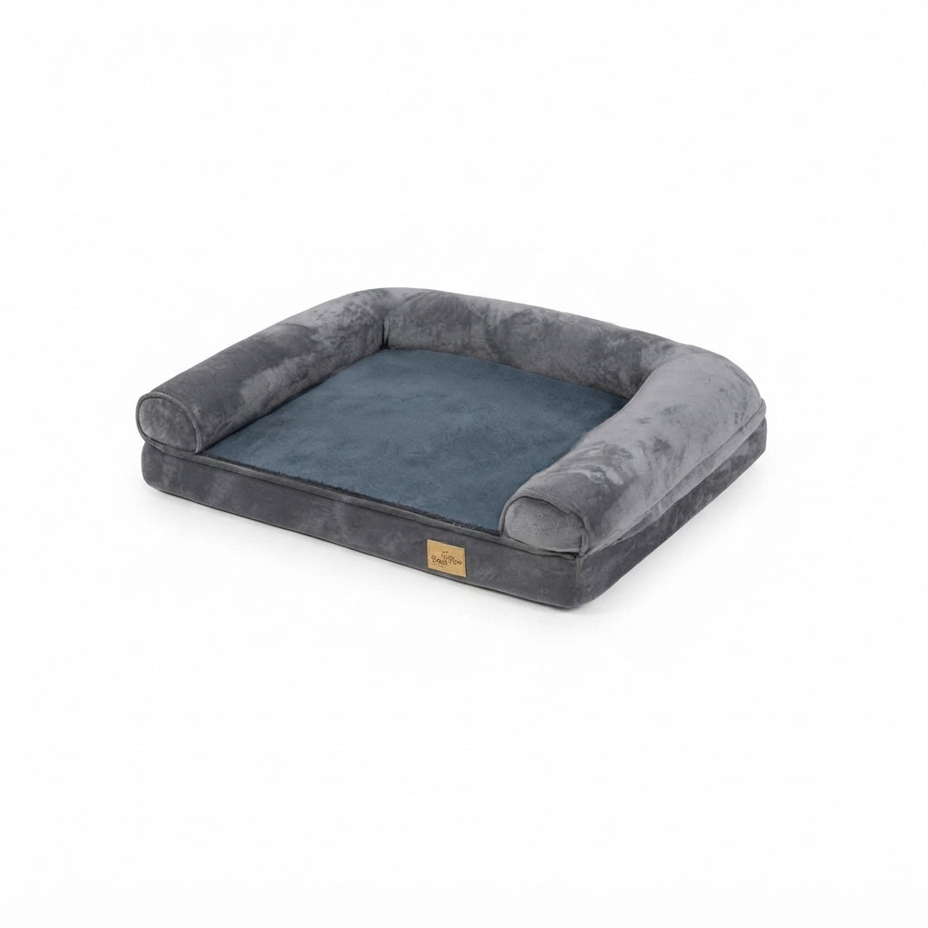 Large dog bed in grey velvet with bolsters on three sides and a blue-grey plush sleeping area