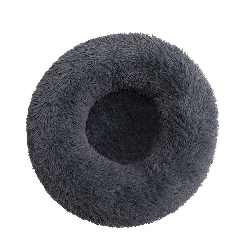 Round donut dog bed in charcoal shaggy plush, a dark slate grey with a central hollow, seen from above