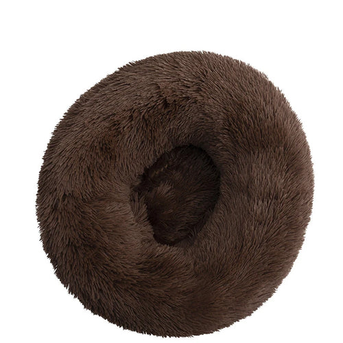 Round donut dog bed in chocolate shaggy plush, dark brown with a deep central hollow, seen from above