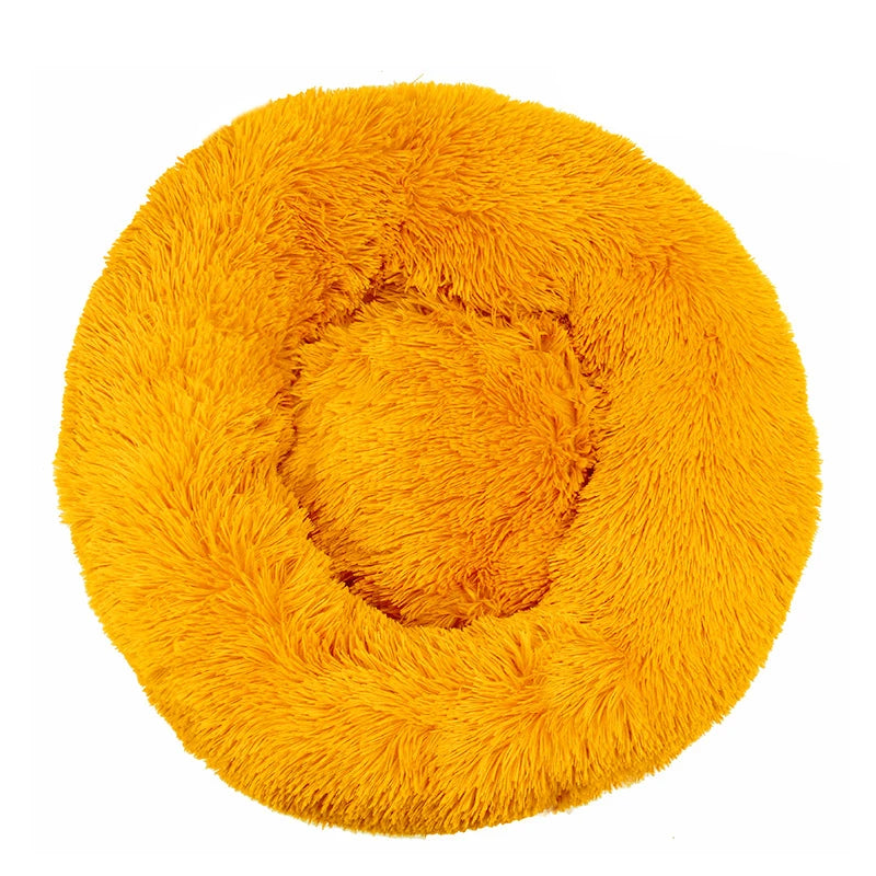 Round donut dog bed in mustard shaggy plush, a bright golden yellow with a raised rim, seen from above