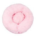 Large donut dog bed in pale pink shaggy plush, a round bed with a thick raised rim, seen from above