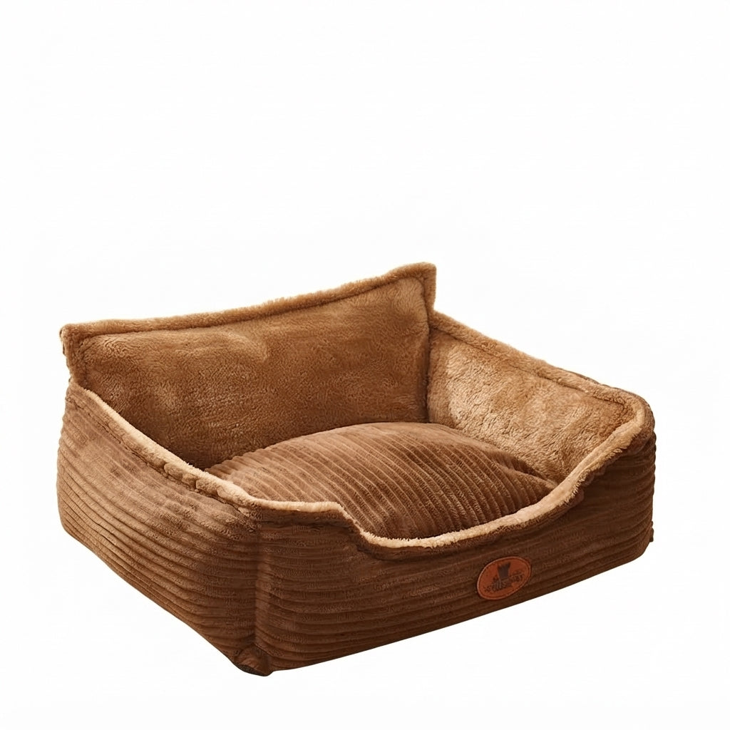 Nest dog bed in coffee brown corduroy with a high plush back, a low front and a ribbed cushion inside