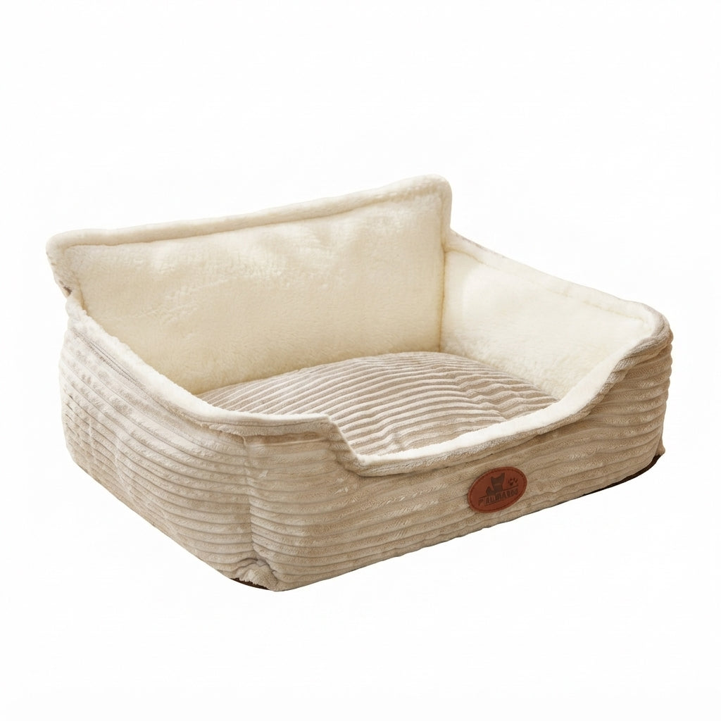 Nest dog bed in cream corduroy with a high white plush back, a ribbed cushion and a round brown patch on the front