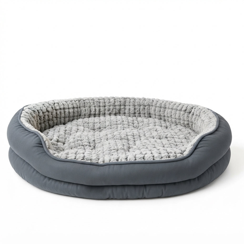 Oval donut dog bed with a dark grey outer rim and a pale grey textured plush lining