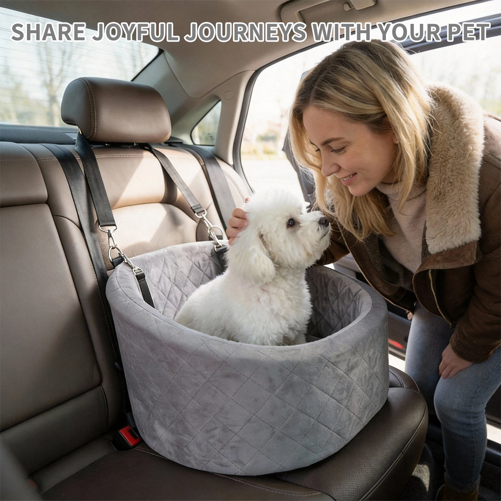 Grey oval travel bed strapped to a car back seat, a small white dog inside greeting a smiling woman