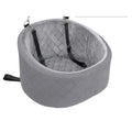 Oval travel dog bed in grey diamond-quilted velvet, with two black straps and clips to fix it to a car seat