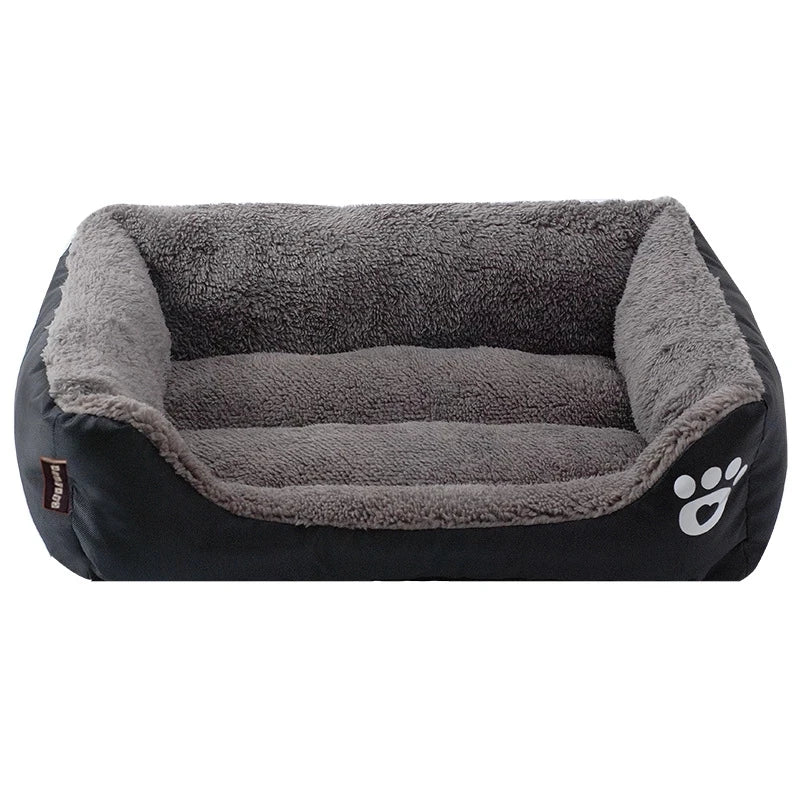 Rectangular dog bed in black Oxford cloth with a grey plush lining and a white paw print on the front corner