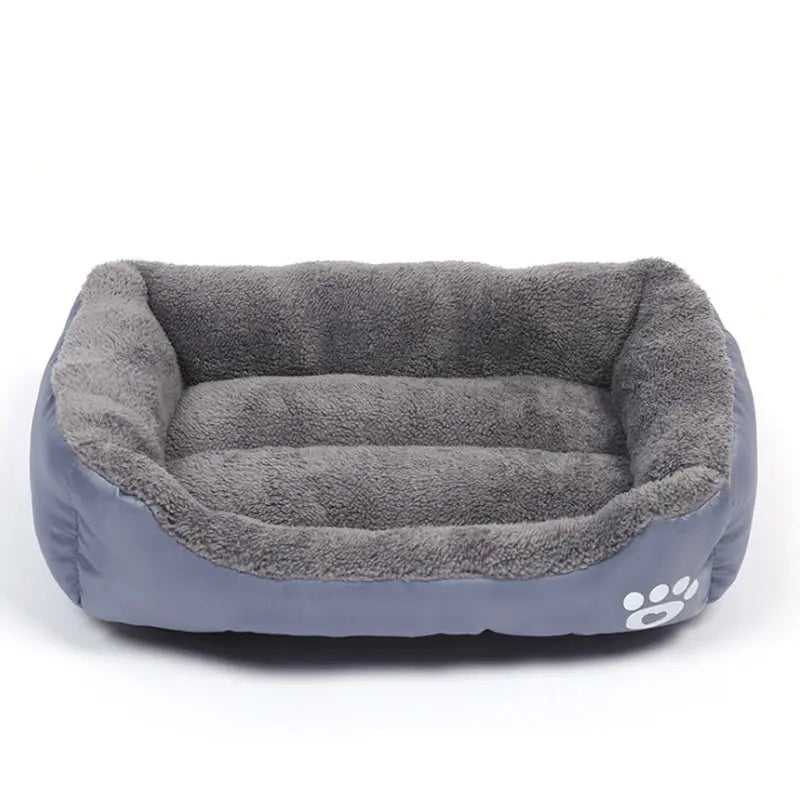 Rectangular dog bed in grey Oxford cloth with a darker grey plush lining and a white paw print