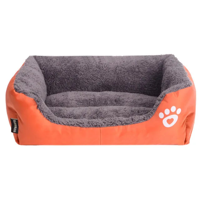 Rectangular dog bed in orange Oxford cloth with a grey plush lining and a white paw print, seen from the front