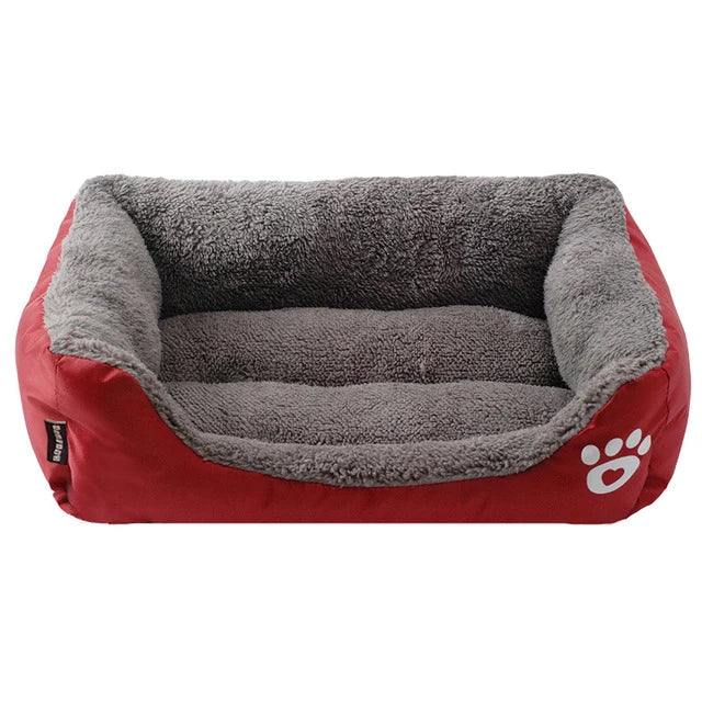 Rectangular dog bed in wine red Oxford cloth with a grey plush lining and a white paw print, seen from the front