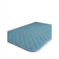 Pet mat in teal quilted fabric with diamond stitching, pale blue binding and rounded corners