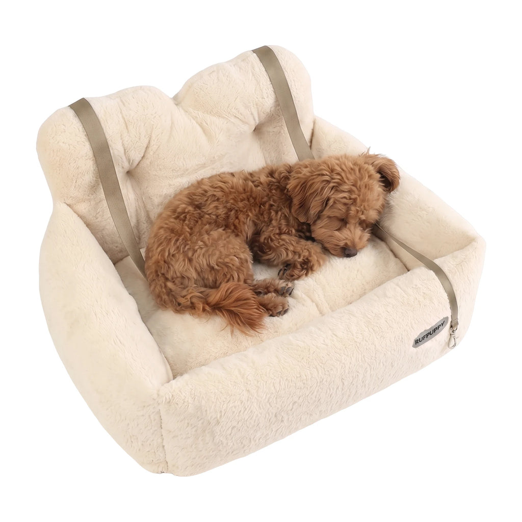 Plush dog bed for car boot and back seat in cream faux fur, a small curly brown dog asleep inside