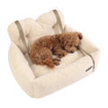 Plush dog bed for car boot and back seat in cream faux fur, a small curly brown dog asleep inside