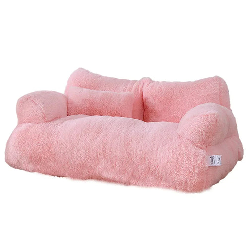 Plush two-seater sofa cat bed in pink faux fur with rounded armrests, a split backrest and a small pillow