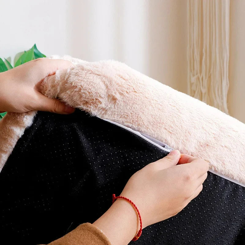 Hands unzipping the plush cover of the sofa cat bed to show the black non-slip base underneath