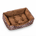 Rectangular dog bed in giraffe print with a brown and cream outer wall and a tufted brown velvet cushion