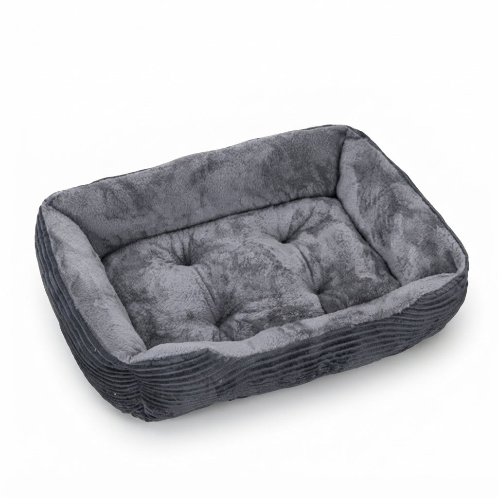 Rectangular dog bed in dark grey corduroy with a grey plush lining and a tufted grey cushion