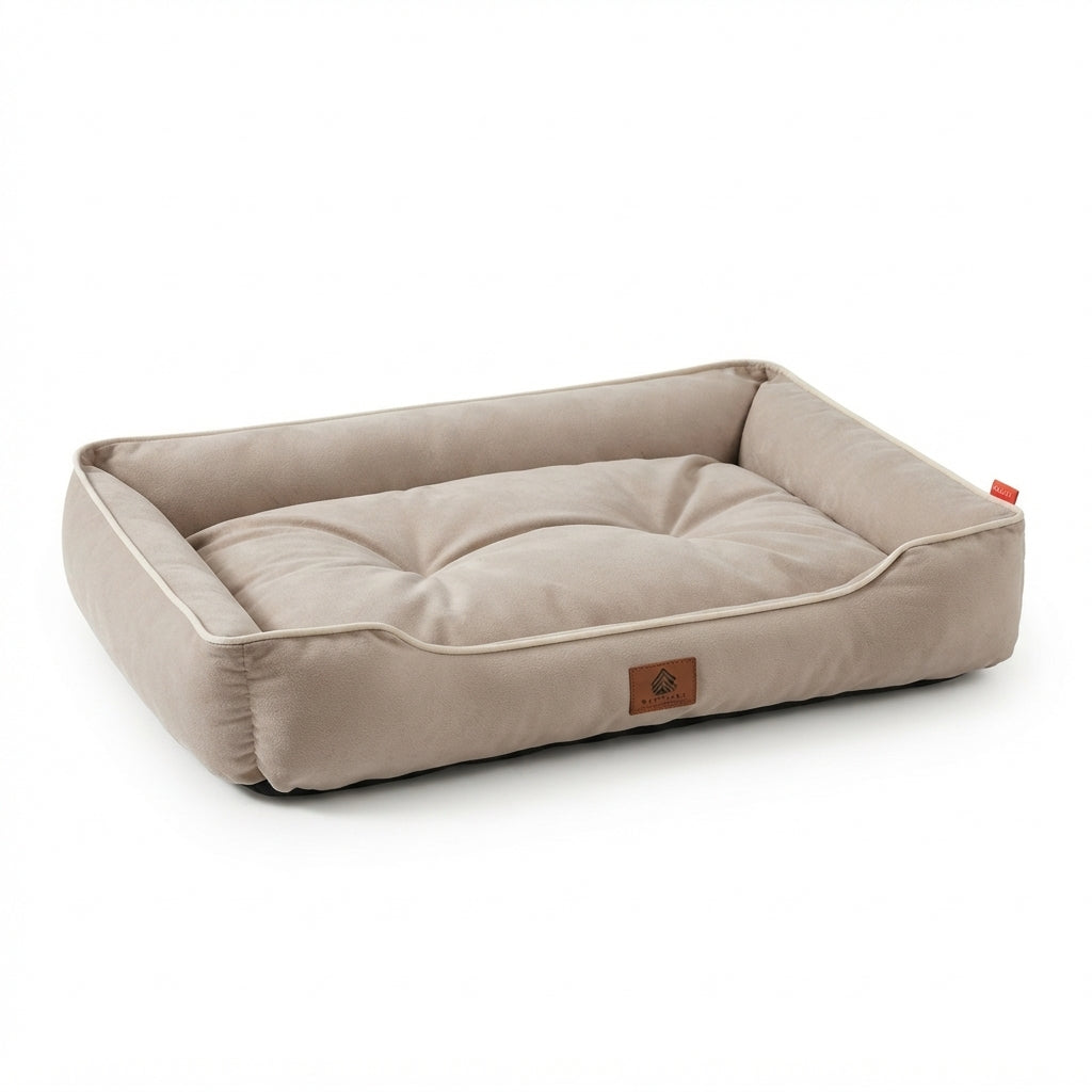 Rectangular dog bed in plain beige velvet-look fabric with cream piping and a tufted cushion