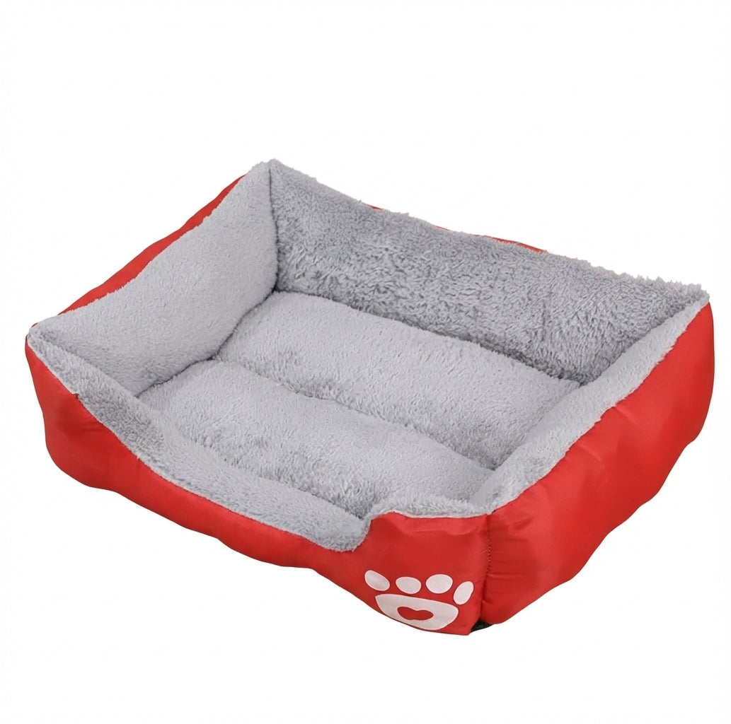 Washable dog bed in red Oxford cloth, rectangular with a grey plush lining and a white paw print on the front