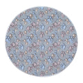 Round cat mat in blue-grey plush printed with blue, pink and beige paw prints, a cream fleece edge showing