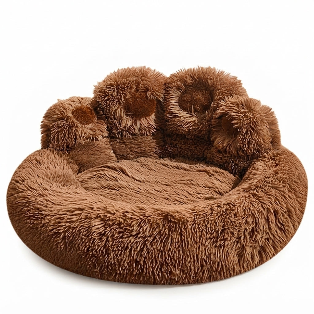 Paw-shaped round dog bed in brown long plush, the four toes forming a raised back with darker pads