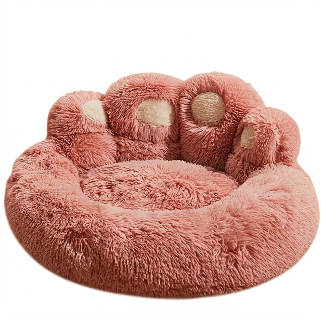 Paw-shaped round dog bed in dusty pink long plush with four beige toe pads along the back