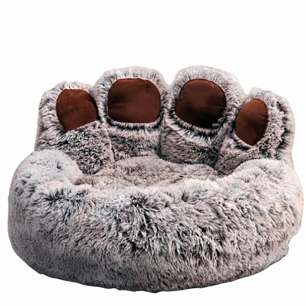 Paw-shaped round dog bed in frosted grey plush with dark roots and pale tips, and brown toe pads