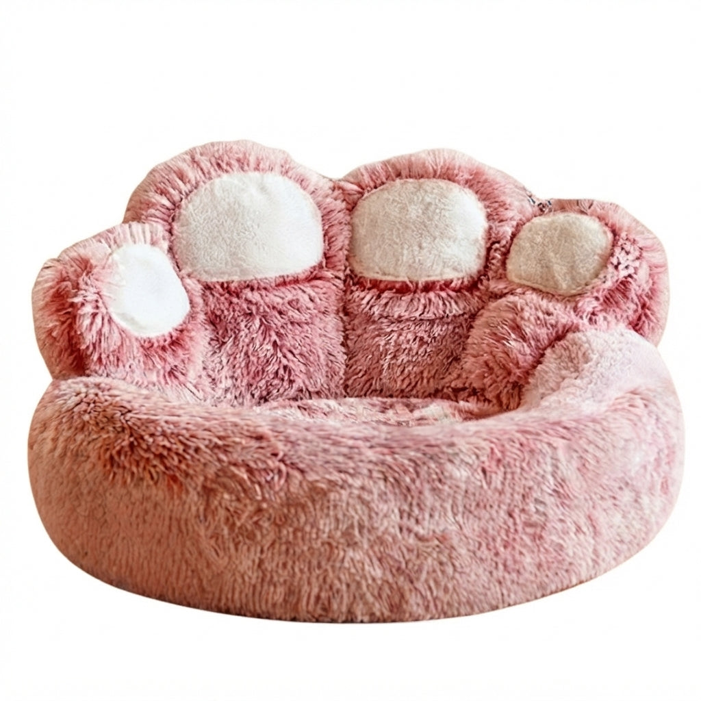 Round dog bed shaped like a giant paw in pink tie-dye long plush, with four cream toe pads along the back