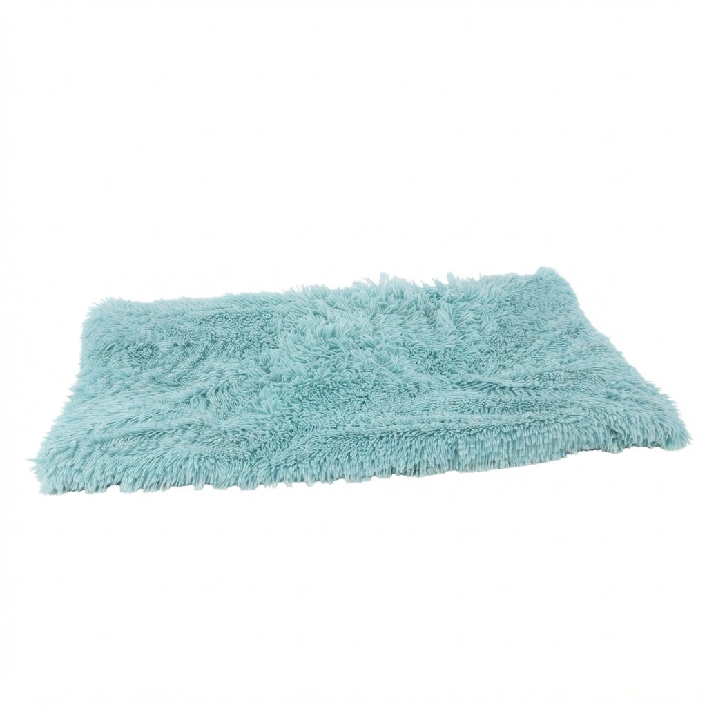 Shaggy dog blanket in teal long-pile plush, a light aqua rectangle seen at an angle
