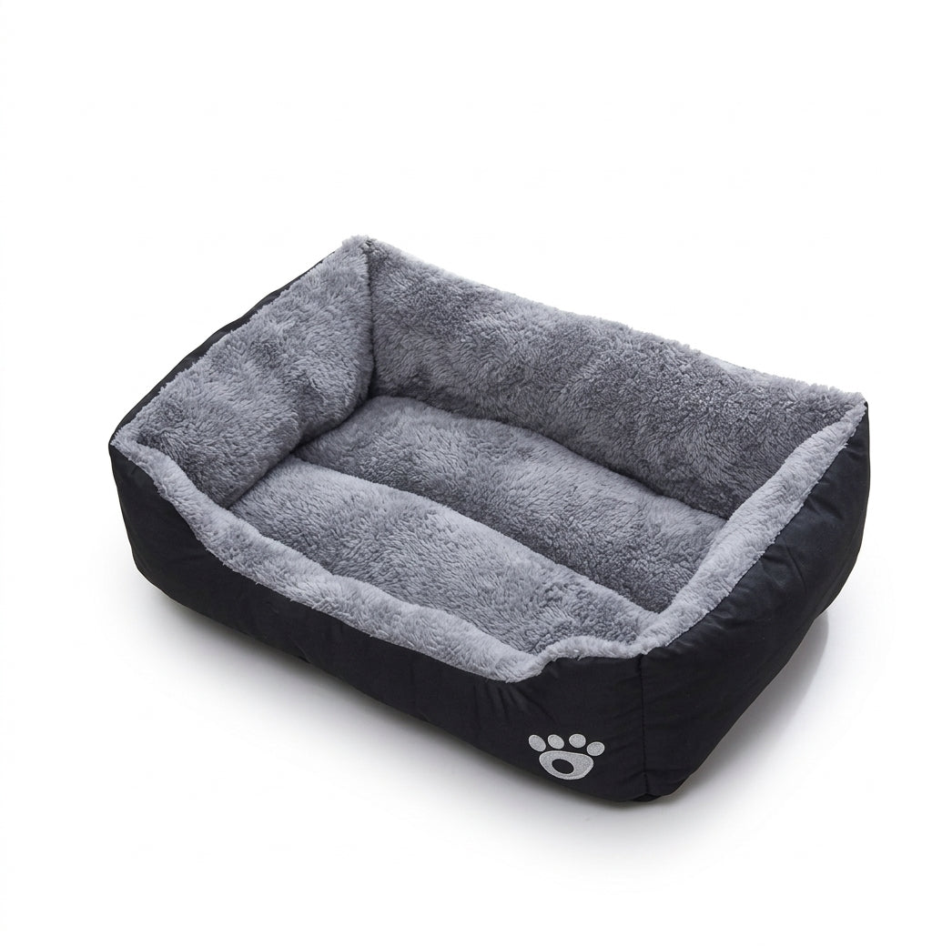 Rectangular dog bed in black paw design: black fabric sides with a grey paw print and a grey plush lining