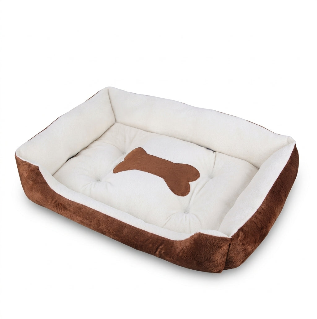 Rectangular dog bed in brown bone design: brown plush sides, cream lining and a brown bone patch on the cushion