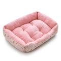 Rectangular dog bed in pink print, with small cartoon cats on the pink sides and a fluffy pink plush lining