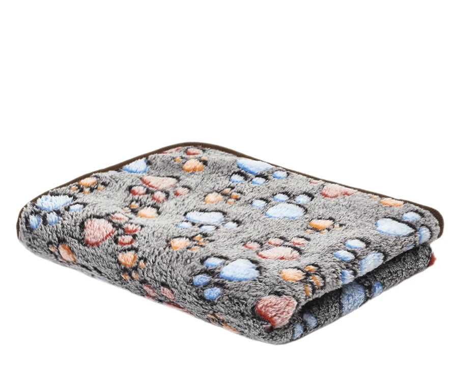 Folded coffee footprints coral fleece blanket, greyish brown with blue, pink and orange paw prints