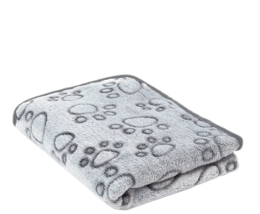 Folded light grey fleece blanket with grey footprints printed in dark grey outline, grey edging