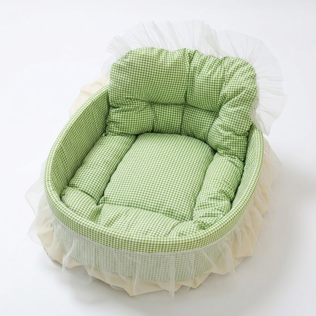 Oval sofa cat bed in green gingham with a padded backrest and cushion, trimmed with a cream tulle skirt