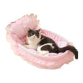 Grey and white cat lying in a pink gingham sofa cat bed with a padded backrest and pink tulle lace skirt