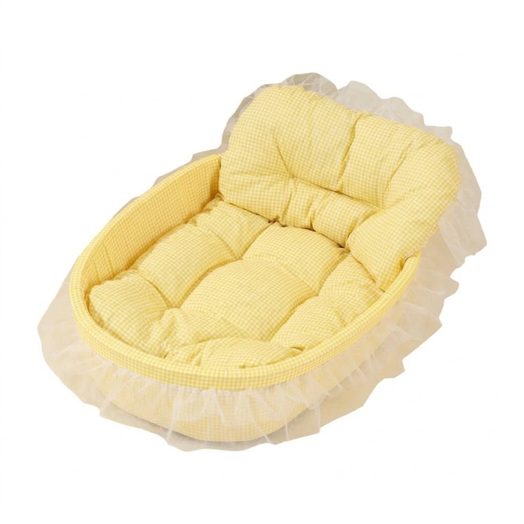Oval sofa cat bed in yellow gingham with a padded backrest and cushion, trimmed with a cream tulle skirt
