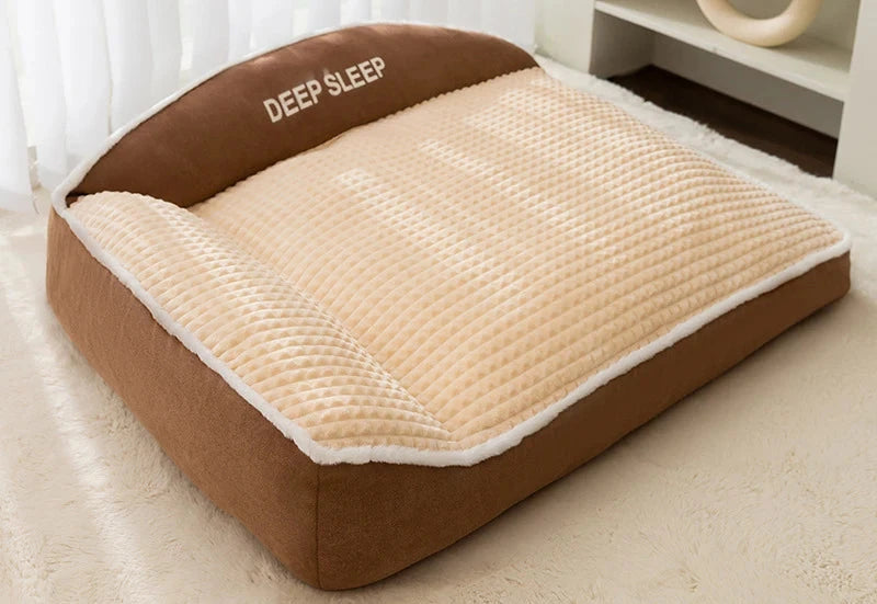 Sofa-style dog bed in brown and cream: brown base and backrest with a cream waffle-textured cushion, on a white rug