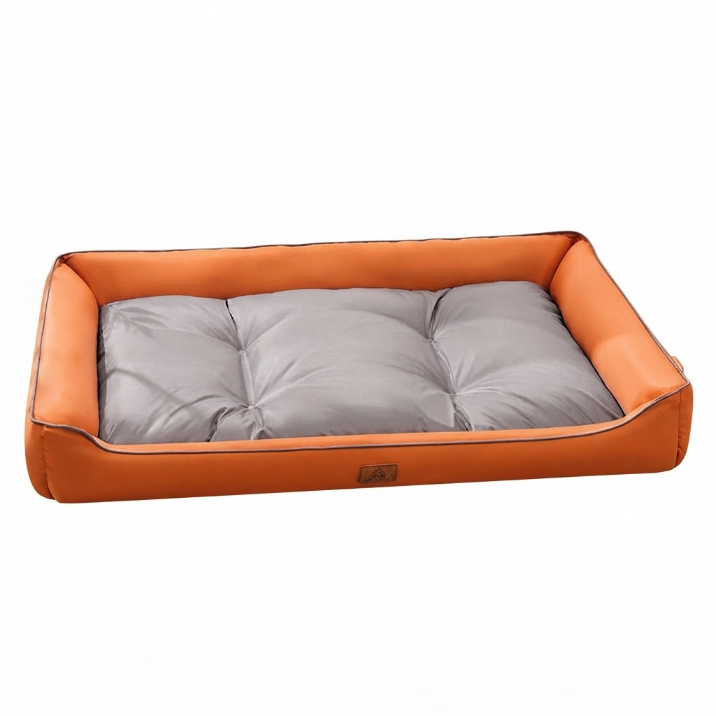 Soft bedding for dogs: a rectangular bed, two-tone orange and grey, with an orange frame and a tufted grey cushion