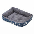 Soft dog bed in navy cat print canvas, rectangular with white cartoon cat faces on the sides and a grey plush lining