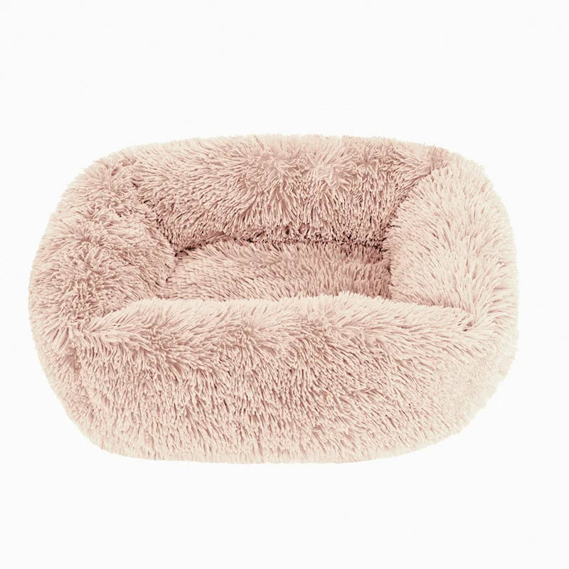 Square dog bed in pale blush beige long plush, with high fluffy walls around a padded base