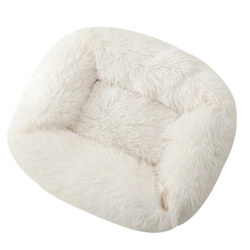 Square dog bed in white long plush, with padded walls on all four sides and a soft centre cushion