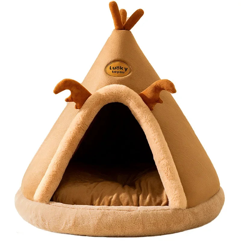Teepee pet cave bed in tan, a cone-shaped tent with a plush doorway trim, felt antlers and a cushion inside