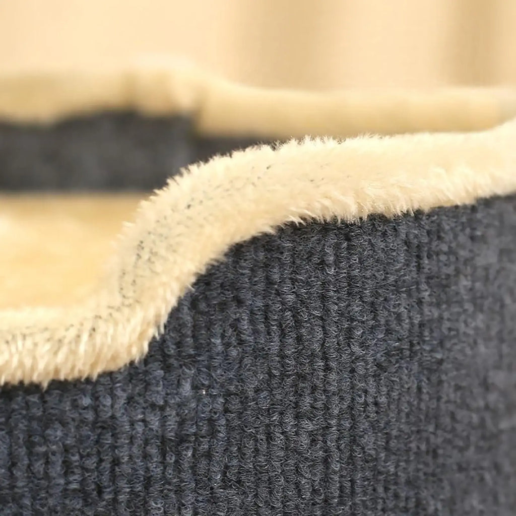 Close-up of the beige plush trim along the top edge of the grey ribbed fabric on the cat house