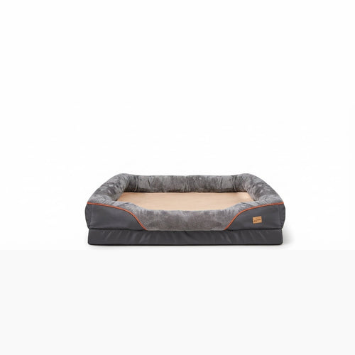 Washable dog bed for large dogs in grey, with plush bolsters, a beige sleeping pad and orange piping on a foam base